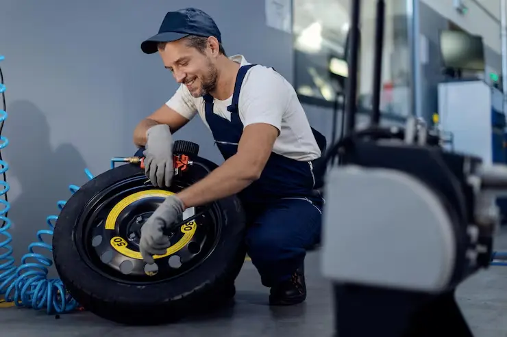 Mobile tyre technician fitting tyre